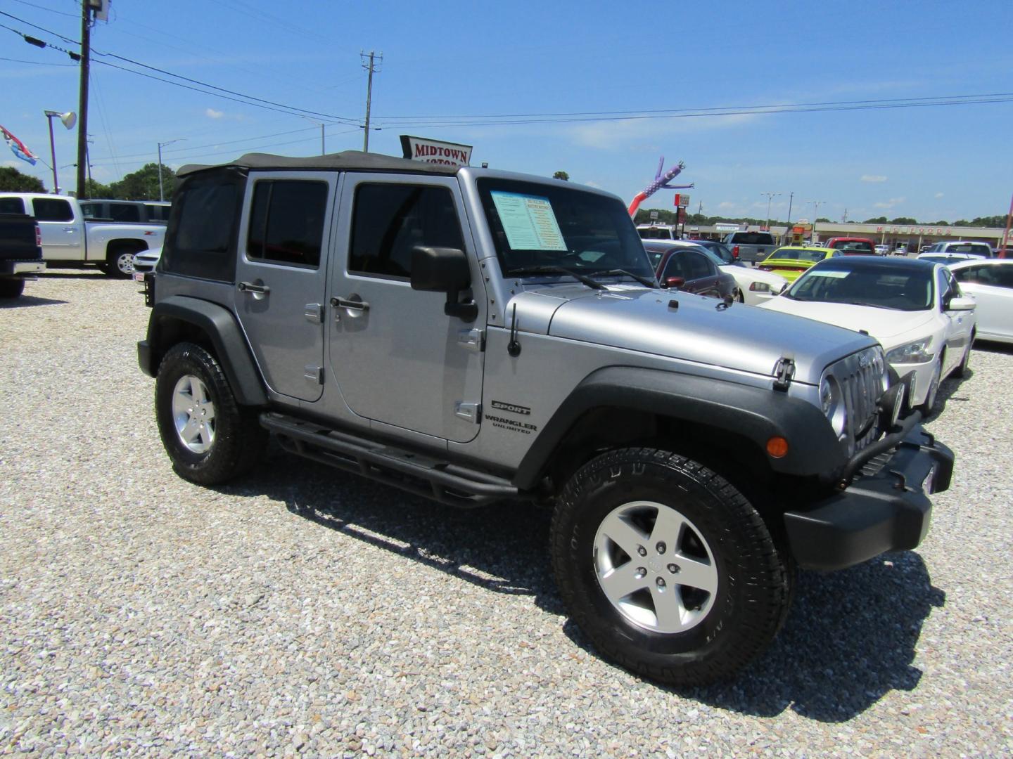 2013 Silver Jeep Wrangler Unlimited Sport 4WD (1C4BJWDG2DL) with an 3.6L V6 DOHC 24V FFV engine, Automatic transmission, located at 15016 S Hwy 231, Midland City, AL, 36350, (334) 983-3001, 31.306210, -85.495277 - Photo#0